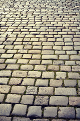 Vintage toned cobblestones at sunrise, street in Poznan, Poland.