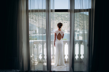 Bride on the balcony in lace dress