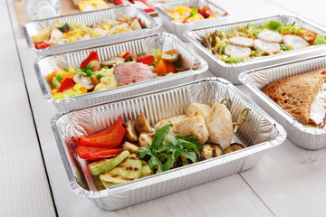 Healthy food take away in boxes, top view at wood