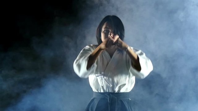 beautiful girl doing aikido, smoke, slow motion