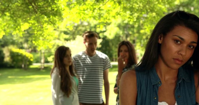 Friends university student teasing a student alone at school