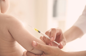 Professional pediatrician vaccinating baby, close up - obrazy, fototapety, plakaty