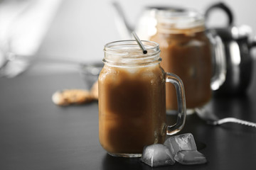 Iced coffee in glass jar on black table