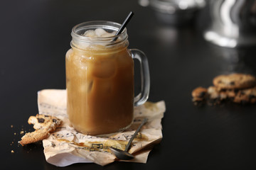 Iced coffee in glass jar on black table