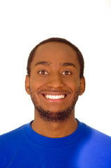 Headshot handsome man wearing strong blue colored t-shirt smiling to camera, white studio background