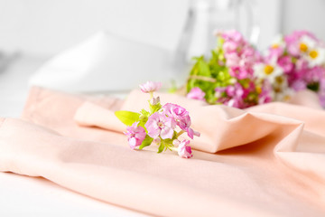 Beautiful bouquet of meadow flowers on pink napkin