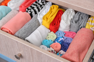 Neatly folded clothes in chest of drawers