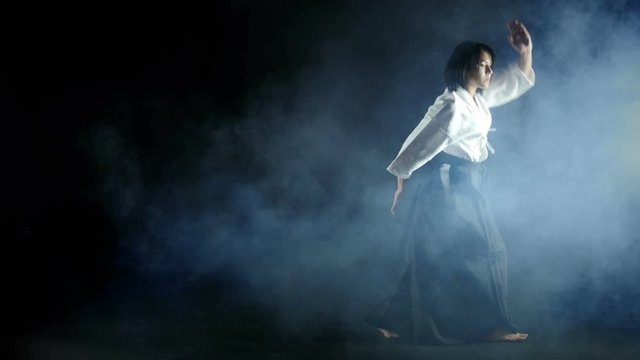  beautiful girl doing aikido, smoke