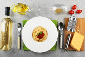 Composition of spaghetti in white plate on gray background