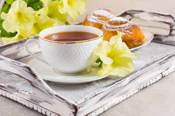 Breakfast Danish pastry and cup of tea on vintage serving tray