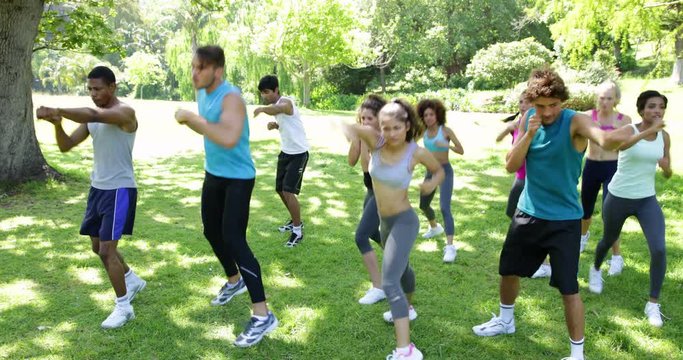 Boot camp class punching on the spot