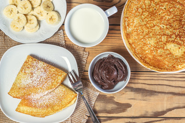 Pancakes with a banana and Cup of milk