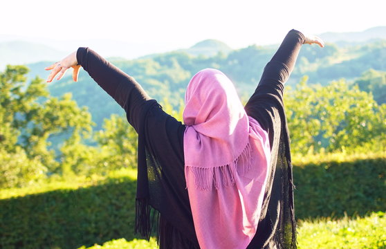 Muslim woman with veil spending good time at sunny day