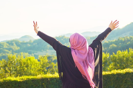Muslim woman with veil spending good time at sunny day