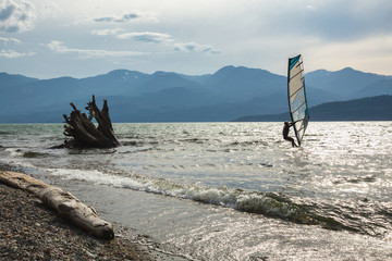 Fototapeta premium Windsurfer surfing in Harrison Lake, British Columbia, Canada.