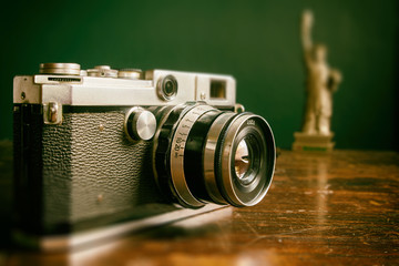 Vintage Camera with land mark mini model. Image made vintage tone.