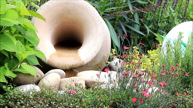 amphora with flowing water, garden decoration
