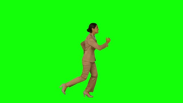 Businesswoman running in a hurry on green screen background