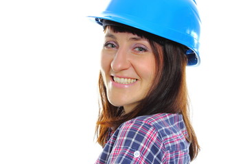 Smiling builder woman wearing protective blue helmet