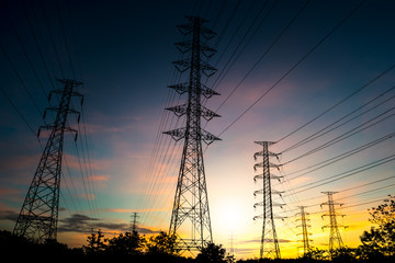 Fototapeta premium Silhouette High voltage post. High-voltage tower on sunrise background