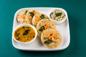 south indian favourite food rava idli or semolina idly or rava idly, served with sambar and green...
