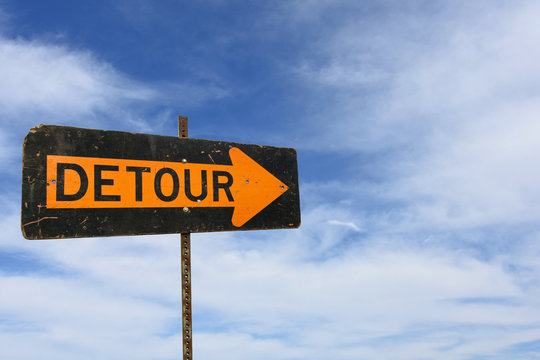 detour sign with wispy clouds in summer sky background