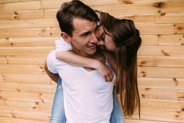 couple posing on a background of the wooden wall