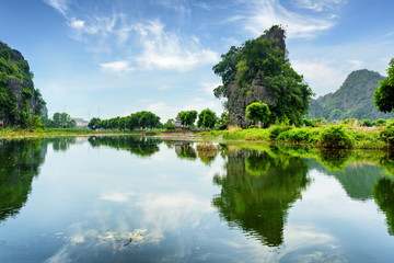 Fototapeta premium Beautiful natural karst towers reflected in the Ngo Dong River