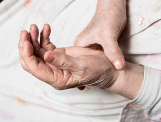 Fototapeta premium Old woman measuring her pulse