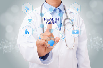 Doctor hand touching HEALTH CARE sign on virtual screen. medical concept
