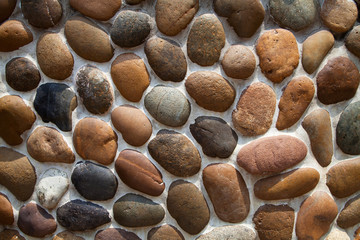Gray and brown pebble stone mosaic wall textured background