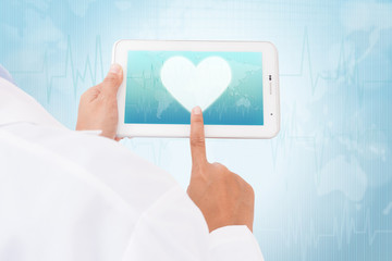 Doctor hand touch screen heart symbol on a tablet. medical icon