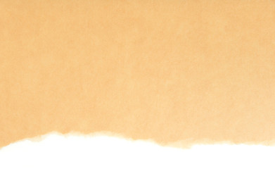 Brown wrapping paper torn to reveal white background