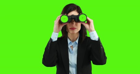 Businesswoman using binoculars on green screen - Powered by Adobe