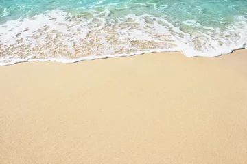 Foto auf Acrylglas Wasser Soft wave of blue ocean on the sandy beach, background.