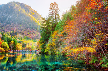 Beautiful view of the Five Flower Lake among scenic fall woods