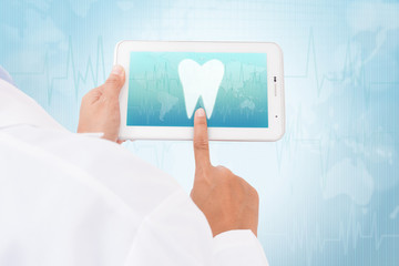 Doctor hand touch screen Tooth symbol on a tablet. medical icon