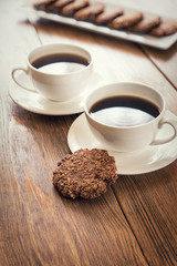 Oatmeal cookies and coffee on the wooden table