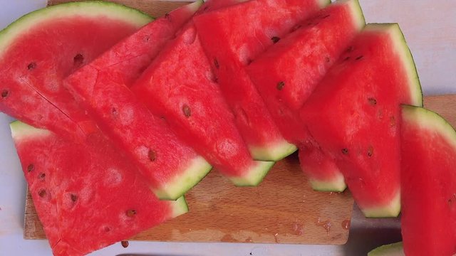 Sweet and tasty watermelon fruit slices on rustic wooden table, top view