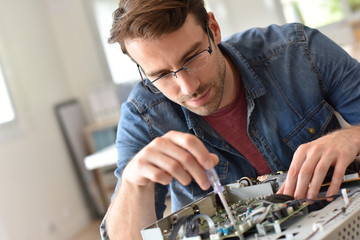 Repairman fixing tv set