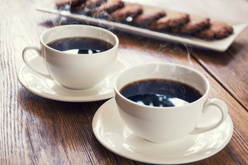 Two cups of hot coffee