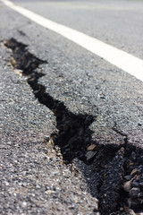 Close cracked asphalt blur.