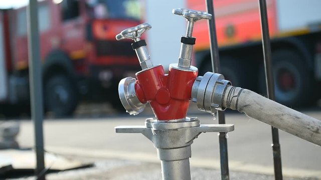 Water hose connected to hydrant during firefighting operation
