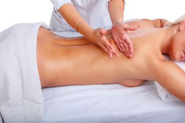 Female enjoing relaxing back massage in therapist centre.