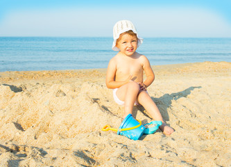 Baby playing on the sandy beach