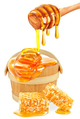 honey dripping in a bucket and honeycombs 