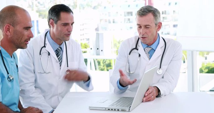 Video of medical team looking at laptop computer