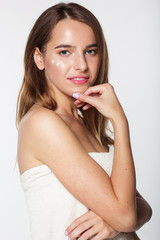 Fototapeta premium Girl with moisturizing cream on her face