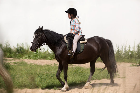 happy young girl riding horse
