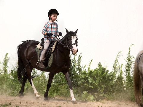 happy young girl riding horse
